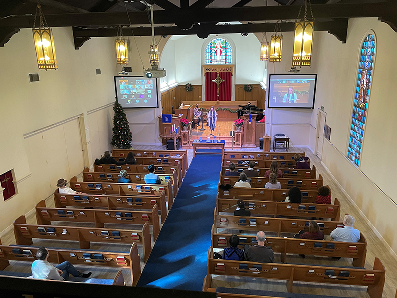 Church sanctuary seen from above, showing video screens and seating capacity